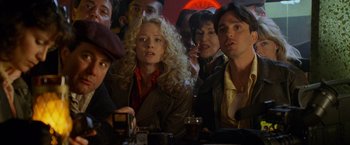 Movie still from “Godzilla” (1998), directed by Roland Emmerich – A group of people sitting at a table with drinks; Close Up shot, Low angle