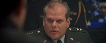 Movie still from “Godzilla” (1998), directed by Roland Emmerich – A person wearing a military uniform; Close Up shot, Low angle