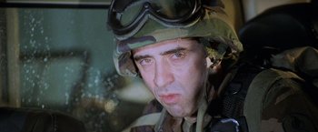Movie still from “Godzilla” (1998), directed by Roland Emmerich – A man in a military uniform wearing a helmet; Close Up shot, Low angle