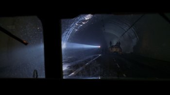 Movie still from “Godzilla” (1998), directed by Roland Emmerich – A train is traveling through a dark tunnel; Extreme Wide shot, High angle