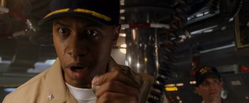 Movie still from “Godzilla” (1998), directed by Roland Emmerich – A man in a baseball cap is eating a sandwich; Close Up shot, Low angle