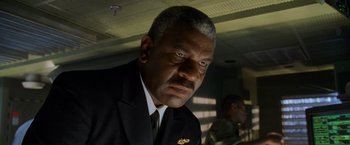 Movie still from “Godzilla” (1998), directed by Roland Emmerich – A man in a suit and tie; Close Up shot, Low angle