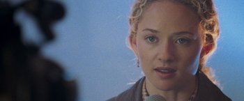 Movie still from “Godzilla” (1998), directed by Roland Emmerich – A person talking on a microphone; Close Up shot, Over the shoulder angle