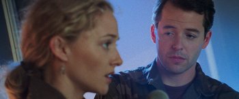 Movie still from “Godzilla” (1998), directed by Roland Emmerich – A man and a woman in front of microphones in a room; Close Up shot, Over the shoulder angle