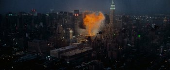 Movie still from “Godzilla” (1998), directed by Roland Emmerich – An airplane is flying through the air near a building; Extreme Wide shot, High angle