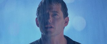 Movie still from “Godzilla” (1998), directed by Roland Emmerich – A man's face in the rain; Close Up shot, Low angle