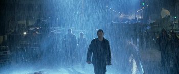 Movie still from “Godzilla” (1998), directed by Roland Emmerich – A man standing in the middle of a rain covered street; Wide shot, Low angle