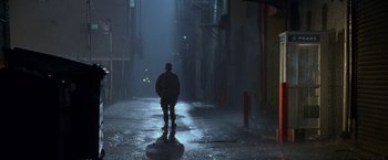 Movie still from “Godzilla” (1998), directed by Roland Emmerich – A man standing in the middle of an alley at night; Wide shot, Low angle