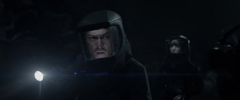 Movie still from “Godzilla” (2014), directed by Gareth Edwards – A man wearing a black helmet and a black jacket; Close Up shot, Low angle