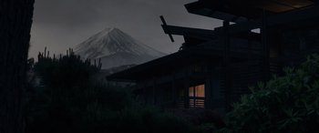 Movie still from “Godzilla” (2014), directed by Gareth Edwards – A house that has a mountain in the background; Extreme Wide shot, Low angle