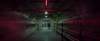 Movie still from “Godzilla” (2014), directed by Gareth Edwards – A man standing in a room with pipes; Extreme Wide shot, Low angle