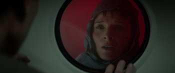 Movie still from “Godzilla” (2014), directed by Gareth Edwards – A woman looking in a mirror with a hood on; Close Up shot, Low angle