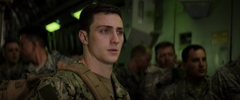 Movie still from “Godzilla” (2014), directed by Gareth Edwards – A man in military fatigues looking into the distance; Close Up shot, Low angle