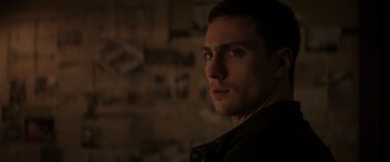 Movie still from “Godzilla” (2014), directed by Gareth Edwards – A person in a dark room; Close Up shot, Over the shoulder angle