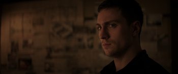 Movie still from “Godzilla” (2014), directed by Gareth Edwards – A person looking at the camera; Close Up shot, Over the shoulder angle