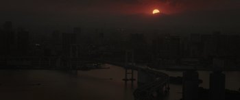 Movie still from “Godzilla” (2014), directed by Gareth Edwards – The sun is setting over a bridge and a river; Extreme Wide shot, High angle