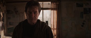 Movie still from “Godzilla” (2014), directed by Gareth Edwards – An older man standing in front of a window; Close Up shot, Over the shoulder angle