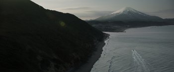 Movie still from “Godzilla” (2014), directed by Gareth Edwards – A body of water near a snowy mountain; Extreme Wide shot, High angle