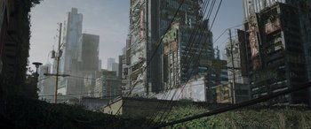 Movie still from “Godzilla” (2014), directed by Gareth Edwards – A large building that has some graffiti on it's side; Extreme Wide shot, Low angle