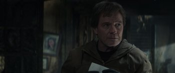 Movie still from “Godzilla” (2014), directed by Gareth Edwards – A person wearing a jacket; Close Up shot, Low angle