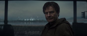 Movie still from “Godzilla” (2014), directed by Gareth Edwards – A person wearing a jacket; Close Up shot, Over the shoulder angle