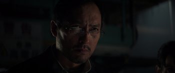 Movie still from “Godzilla” (2014), directed by Gareth Edwards – A person wearing glasses; Close Up shot, Low angle