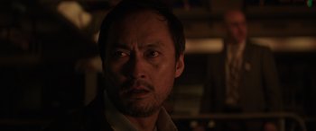 Movie still from “Godzilla” (2014), directed by Gareth Edwards – A person looking at the camera; Close Up shot, Over the shoulder angle