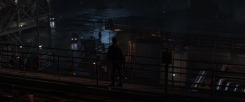 Movie still from “Godzilla” (2014), directed by Gareth Edwards – A man standing on a train platform at night; Extreme Wide shot, High angle