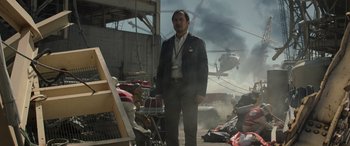 Movie still from “Godzilla” (2014), directed by Gareth Edwards – A man standing in front of a pile of trash; Medium shot, Low angle