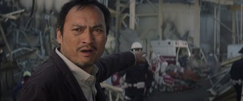 Movie still from “Godzilla” (2014), directed by Gareth Edwards – A person pointing at the camera; Close Up shot, Low angle