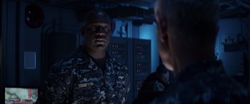 Movie still from “Godzilla” (2014), directed by Gareth Edwards – A man in a military uniform looking at another man in uniform; Medium shot, Over the shoulder angle