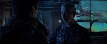 Movie still from “Godzilla” (2014), directed by Gareth Edwards – A man in a uniform talking to another man in a uniform; Close Up shot, Over the shoulder angle
