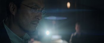 Movie still from “Godzilla” (2014), directed by Gareth Edwards – A person wearing glasses; Close Up shot, Low angle