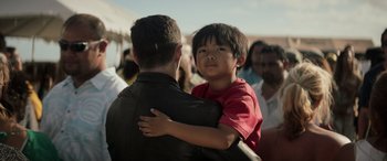 Movie still from “Godzilla” (2014), directed by Gareth Edwards – A man and a boy are hugging each other; Close Up shot, Over the shoulder angle