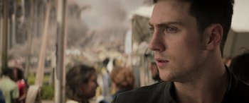 Movie still from “Godzilla” (2014), directed by Gareth Edwards – A man's face in front of a crowd; Close Up shot, Over the shoulder angle