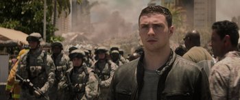 Movie still from “Godzilla” (2014), directed by Gareth Edwards – A man standing in front of a group of soldiers; Close Up shot, Low angle