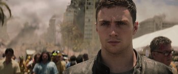 Movie still from “Godzilla” (2014), directed by Gareth Edwards – A person with a crowd of people in the background; Close Up shot, Over the shoulder angle