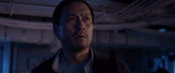 Movie still from “Godzilla” (2014), directed by Gareth Edwards – A person looking at the camera; Close Up shot, Low angle