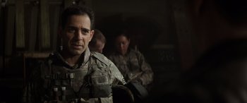 Movie still from “Godzilla” (2014), directed by Gareth Edwards – A man in military fatigues sitting next to another man in fatigues; Close Up shot, Over the shoulder angle