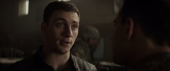 Movie still from “Godzilla” (2014), directed by Gareth Edwards – A man talking to another man in a dark room; Close Up shot, Over the shoulder angle