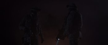 Movie still from “Godzilla” (2014), directed by Gareth Edwards – Two soldiers are standing next to each other in the dark; Medium shot, Low angle