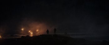 Movie still from “Godzilla” (2014), directed by Gareth Edwards – Two men standing on a hill at night with smoke coming out; Extreme Wide shot, Low angle