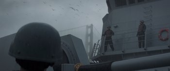 Movie still from “Godzilla” (2014), directed by Gareth Edwards – A man standing on top of a boat in the fog; Wide shot, Low angle