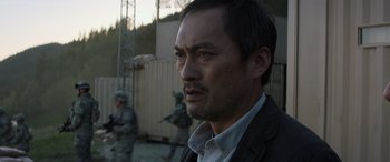 Movie still from “Godzilla” (2014), directed by Gareth Edwards – A person wearing a jacket; Close Up shot, Low angle