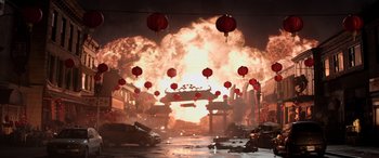 Movie still from “Godzilla” (2014), directed by Gareth Edwards – A street scene with cars and buildings in front of a large explosion; Extreme Wide shot, High angle