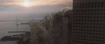 Movie still from “Godzilla” (2014), directed by Gareth Edwards – Smoke billows from a fire that broke out in a city; Extreme Wide shot, High angle