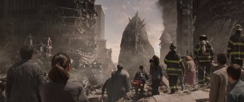 Movie still from “Godzilla” (2014), directed by Gareth Edwards – A group of people standing on top of a pile of rubble; Extreme Wide shot, Low angle