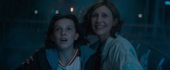 Movie still from “Godzilla: King of the Monsters” (2019), directed by Michael Dougherty – Two people standing next to each other in the dark; Close Up shot, Low angle