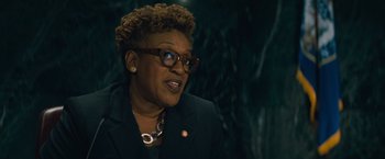 Movie still from “Godzilla: King of the Monsters” (2019), directed by Michael Dougherty – An older woman wearing glasses and a black jacket; Close Up shot, Low angle