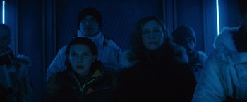 Movie still from “Godzilla: King of the Monsters” (2019), directed by Michael Dougherty – A group of people standing next to each other in the dark; Medium shot, Low angle